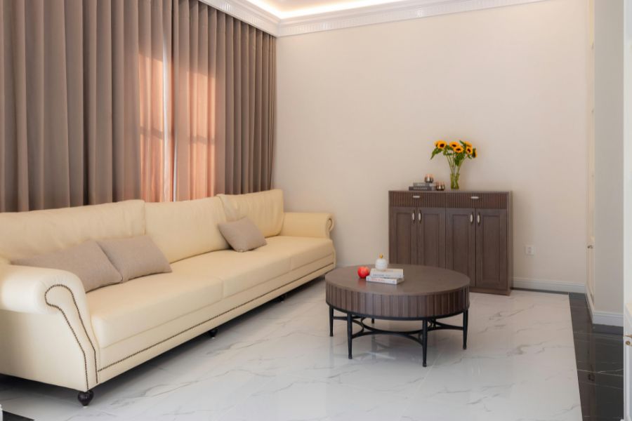 Un long canapé beige élégant installé dans un salon moderne et lumineux.